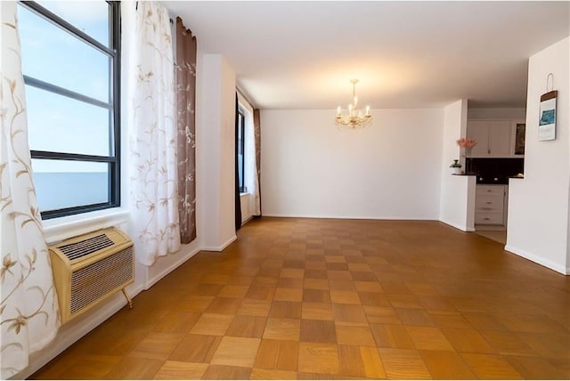40 Brighton 1st Rd Unit 12H, Brooklyn, NY 11235 - empty room featuring a chandelier and a wall unit AC