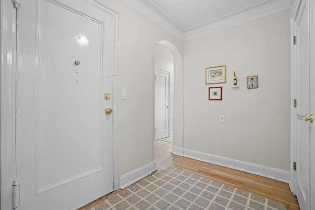 295 N Broadway Unit 27, Yonkers, NY 10701 - foyer entrance with light wood finished floors, arched walkways, crown molding, and baseboards