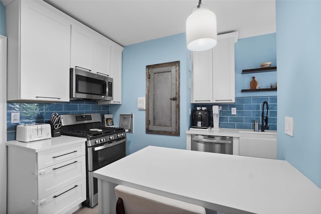 295 N Broadway Unit 27, Yonkers, NY 10701 - kitchen with stainless steel appliances, open shelves, tasteful backsplash, a sink, and light countertops