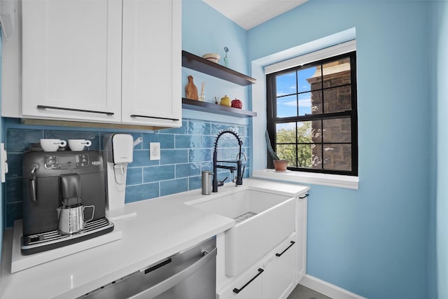 295 N Broadway Unit 27, Yonkers, NY 10701 - kitchen with a sink, decorative backsplash, light countertops, and white cabinetry