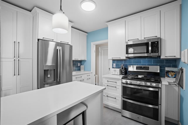 295 N Broadway Unit 27, Yonkers, NY 10701 - kitchen featuring stainless steel appliances, light countertops, backsplash, and white cabinetry