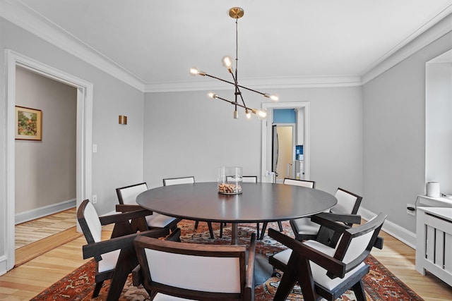 295 N Broadway Unit 27, Yonkers, NY 10701 - dining space featuring a chandelier, light wood-style flooring, baseboards, and ornamental molding
