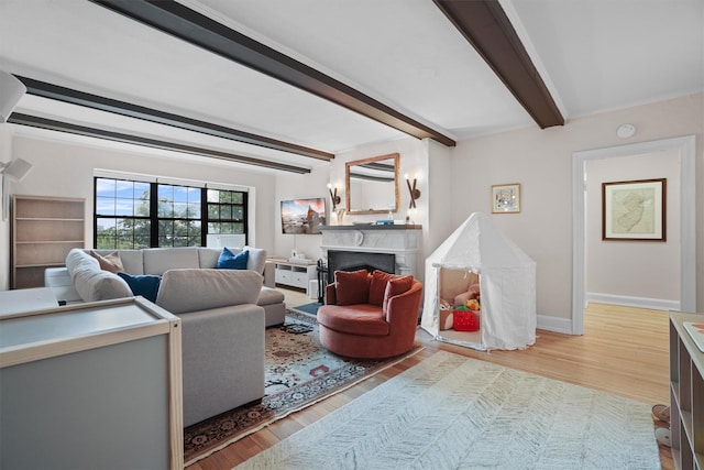 295 N Broadway Unit 27, Yonkers, NY 10701 - living room with beam ceiling, light wood finished floors, a premium fireplace, and baseboards