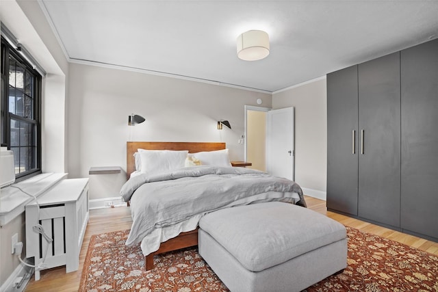 295 N Broadway Unit 27, Yonkers, NY 10701 - bedroom featuring light wood-style flooring, baseboards, and ornamental molding
