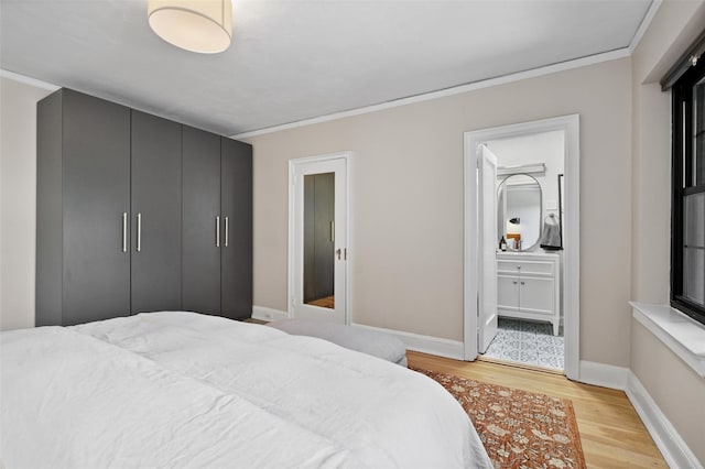 295 N Broadway Unit 27, Yonkers, NY 10701 - bedroom featuring light wood-style floors, baseboards, crown molding, and ensuite bathroom