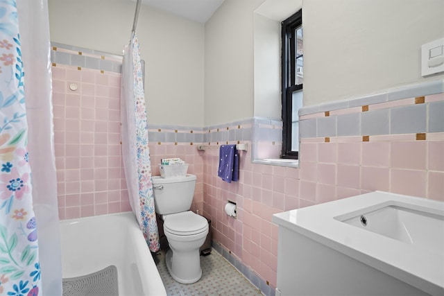 295 N Broadway Unit 27, Yonkers, NY 10701 - bathroom with toilet, vanity, tile walls, shower / tub combo with curtain, and a wainscoted wall