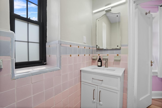 295 N Broadway Unit 27, Yonkers, NY 10701 - bathroom featuring vanity, wainscoting, and tile walls