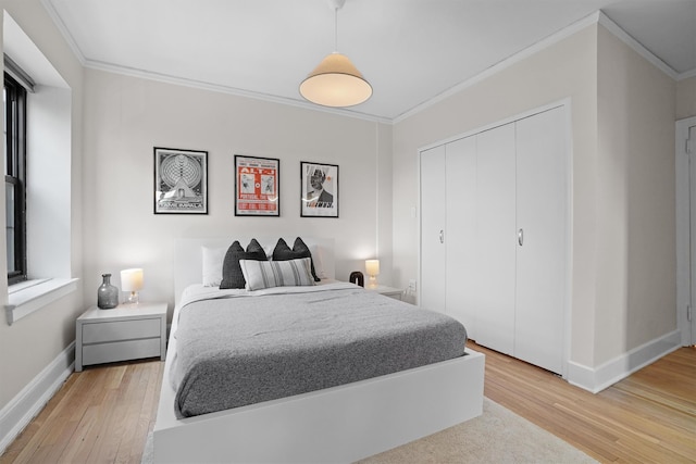 295 N Broadway Unit 27, Yonkers, NY 10701 - bedroom with ornamental molding, light wood finished floors, baseboards, and a closet
