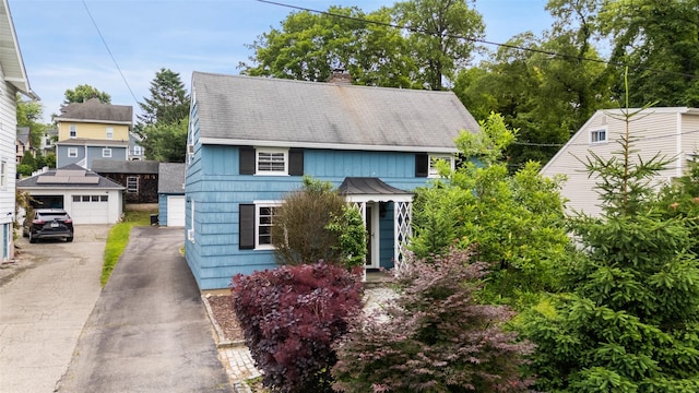 329 Simpson Pl, Peekskill, NY 10566 - view of front facade featuring a chimney, an outdoor structure, and a detached garage