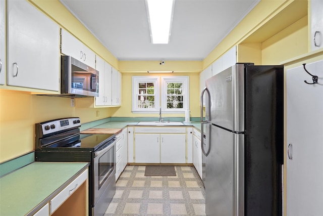 329 Simpson Pl, Peekskill, NY 10566 - kitchen with stainless steel appliances, light countertops, white cabinetry, and light flooring