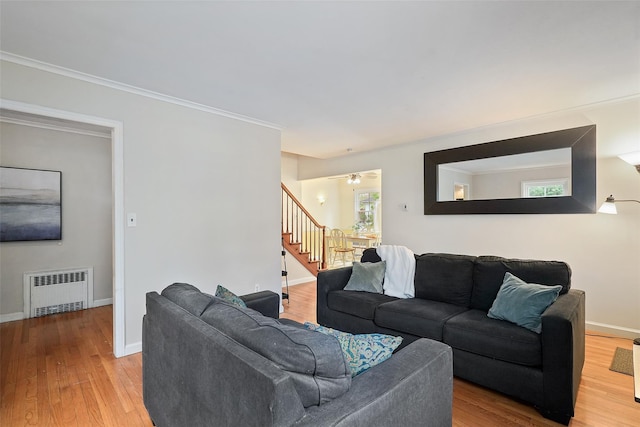 329 Simpson Pl, Peekskill, NY 10566 - living room featuring radiator, stairs, wood finished floors, and ornamental molding