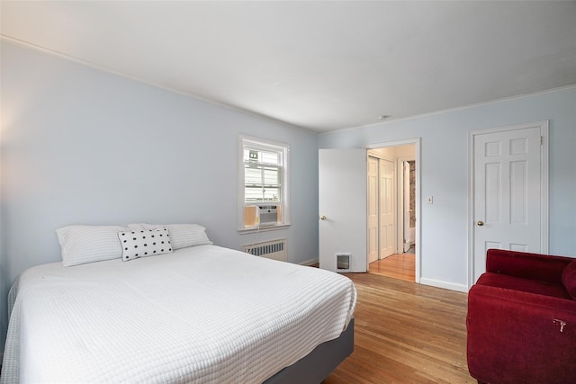 329 Simpson Pl, Peekskill, NY 10566 - bedroom with radiator, wood finished floors, and cooling unit