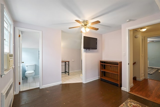 329 Simpson Pl, Peekskill, NY 10566 - unfurnished bedroom with radiator, hardwood / wood-style floors, ensuite bath, and ceiling fan