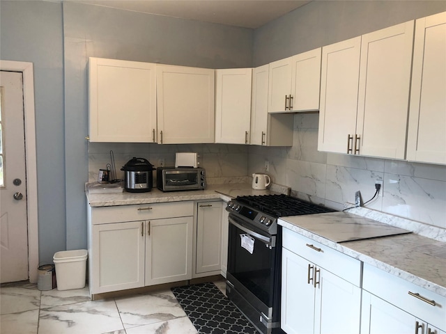 19 Wawayanda Ave, Middletown, NY 10940 - kitchen with black range with gas stovetop, decorative backsplash, light marble finish floors, white cabinetry, and light stone countertops
