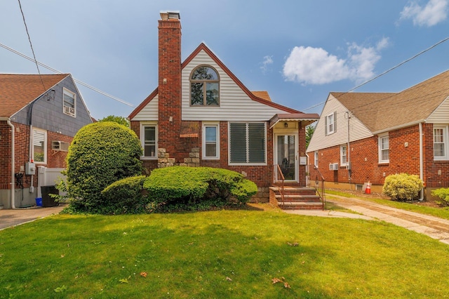 2430 Loft Ave, Baldwin, NY 11510 - view of front of home featuring a chimney, a front lawn, and brick siding