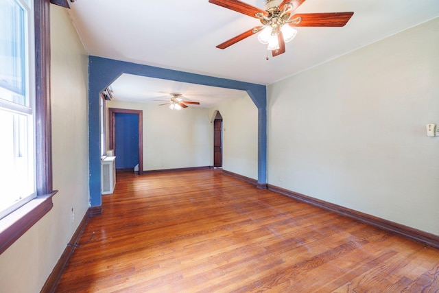 2430 Loft Ave, Baldwin, NY 11510 - unfurnished room with ceiling fan, arched walkways, and light wood-style flooring
