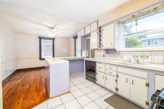 2430 Loft Ave, Baldwin, NY 11510 - kitchen with black dishwasher, healthy amount of natural light, and light countertops