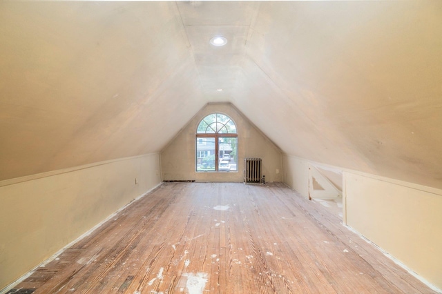 2430 Loft Ave, Baldwin, NY 11510 - bonus room featuring radiator, lofted ceiling, and wood-type flooring