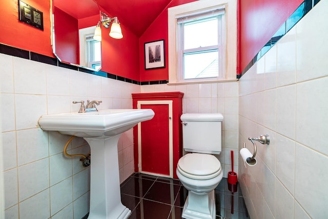 2430 Loft Ave, Baldwin, NY 11510 - bathroom with tile walls, tile patterned flooring, vaulted ceiling, and wainscoting