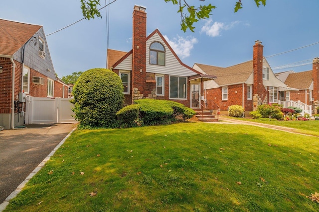 2430 Loft Ave, Baldwin, NY 11510 - view of front of home featuring a gate, a chimney, brick siding, and driveway