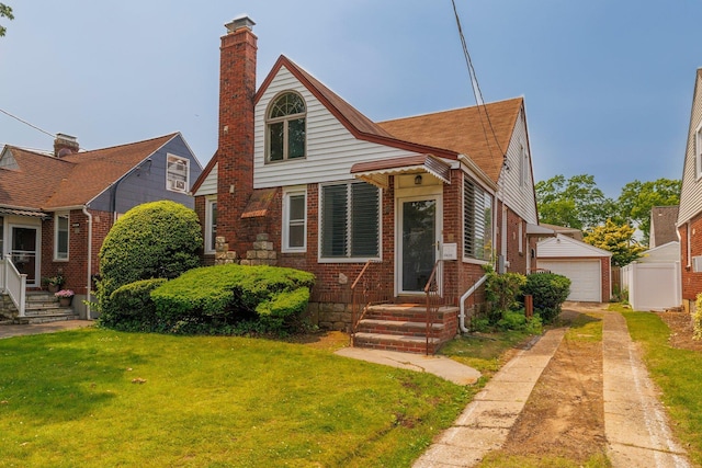 2430 Loft Ave, Baldwin, NY 11510 - view of front of home with entry steps, a front lawn, a chimney, and a detached garage