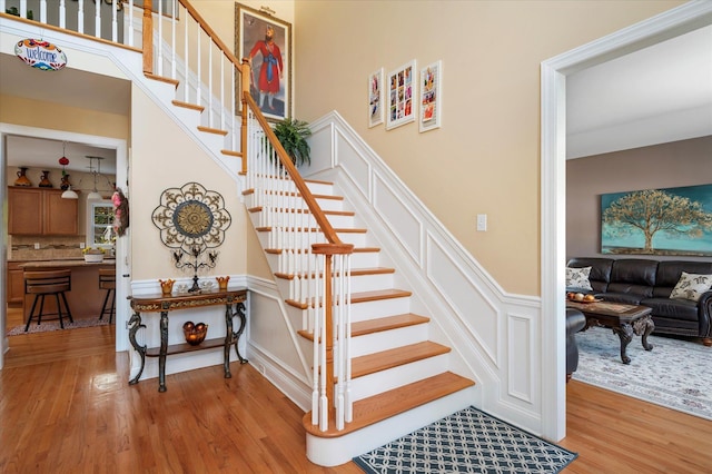 2 Undset Ct, Dix Hills, NY 11746 - stairs with wood finished floors, wainscoting, and a decorative wall