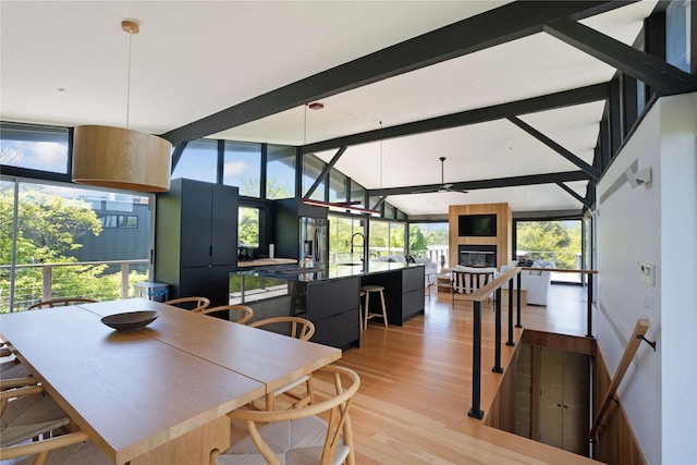 490 Tarpon Walk, Fire Island Pines, NY 11782 - dining space with light wood finished floors, a large fireplace, and a ceiling fan
