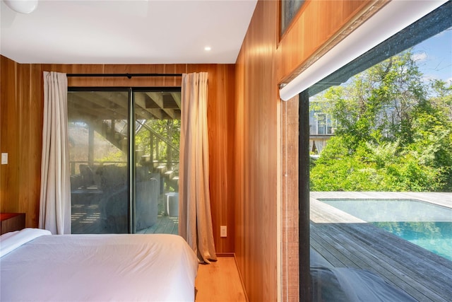 490 Tarpon Walk, Fire Island Pines, NY 11782 - bedroom with access to exterior, wood walls, and wood finished floors