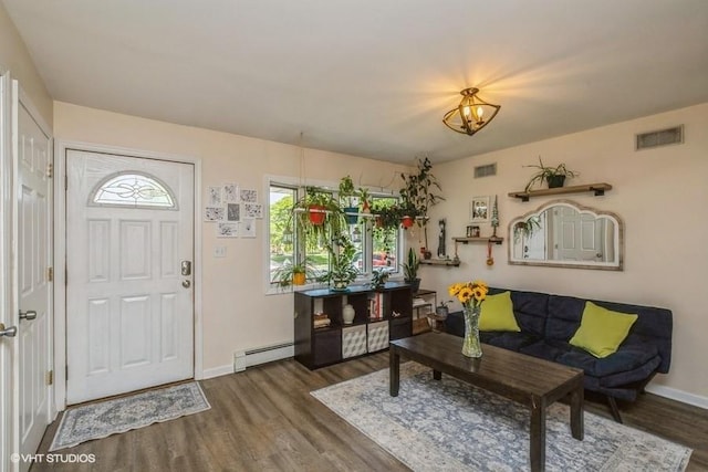 2976 Ruth Rd, Wantagh, NY 11793 - foyer entrance featuring baseboard heating, wood finished floors, baseboards, and a chandelier