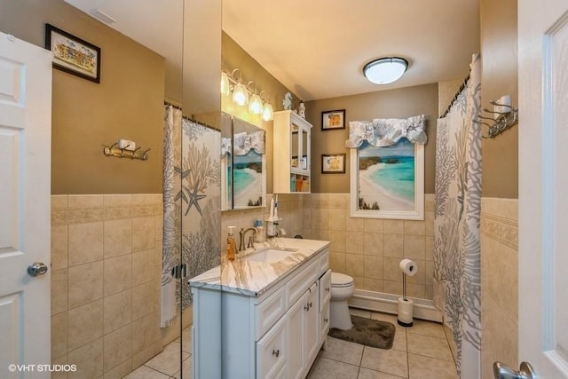 2976 Ruth Rd, Wantagh, NY 11793 - bathroom featuring tile walls, tile patterned floors, wainscoting, vanity, and toilet