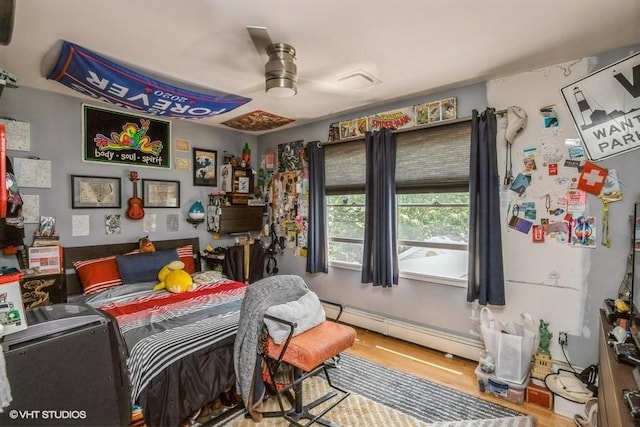 2976 Ruth Rd, Wantagh, NY 11793 - bedroom with a baseboard heating unit, wood finished floors, and ceiling fan