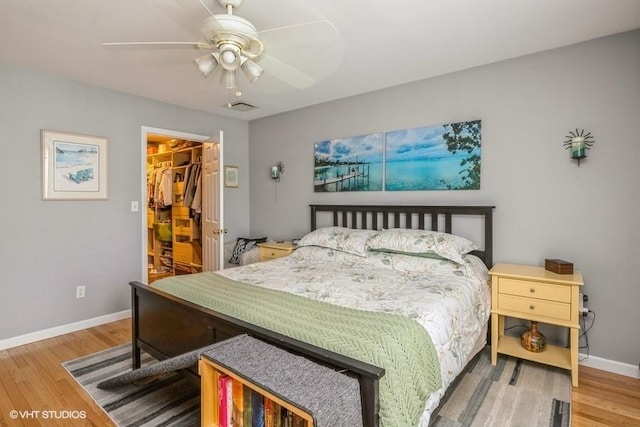 2976 Ruth Rd, Wantagh, NY 11793 - bedroom with a spacious closet, wood finished floors, baseboards, a closet, and a ceiling fan