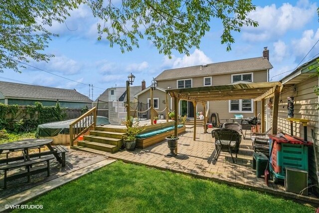 2976 Ruth Rd, Wantagh, NY 11793 - back of property featuring a pergola, a covered hot tub, a patio area, and a deck