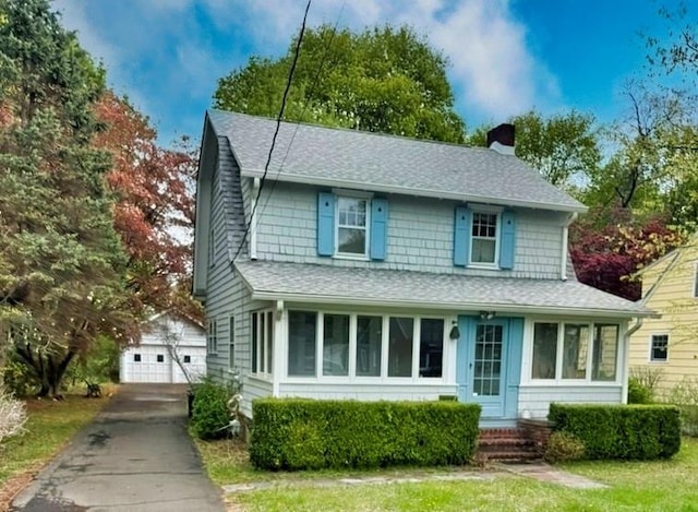 18 Orchard St, Montebello, NY 10901 - view of front of home featuring a chimney, an outdoor structure, a shingled roof, and a detached garage
