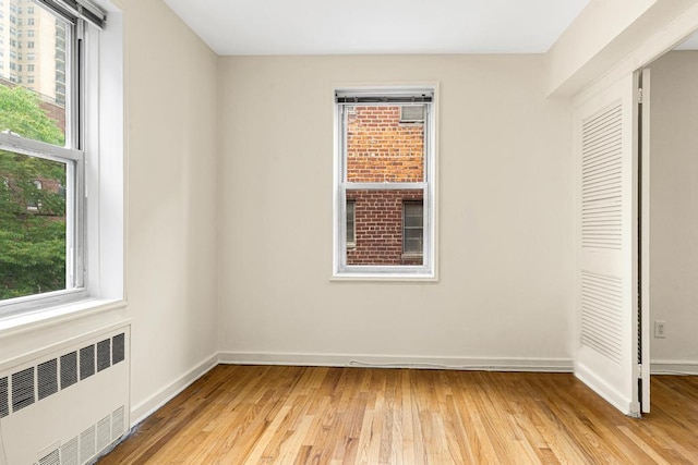 72-10 112th St Unit 5B, Forest Hills, NY 11375 - unfurnished room featuring radiator heating unit, light wood-style flooring, and baseboards
