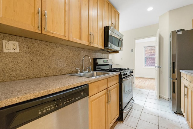 72-10 112th St Unit 5B, Forest Hills, NY 11375 - kitchen featuring stainless steel appliances, a sink, backsplash, light tile patterned flooring, and light countertops