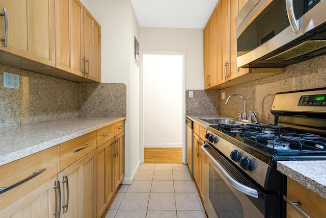 72-10 112th St Unit 5B, Forest Hills, NY 11375 - kitchen featuring stainless steel appliances, a sink, light tile patterned flooring, and backsplash