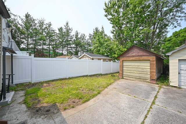 43-24 219th St, Bayside, NY 11361 - view of yard featuring a detached garage and an outbuilding