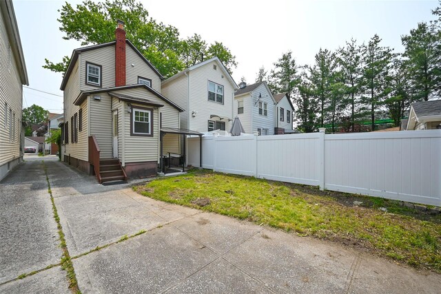 43-24 219th St, Bayside, NY 11361 - back of house featuring a chimney