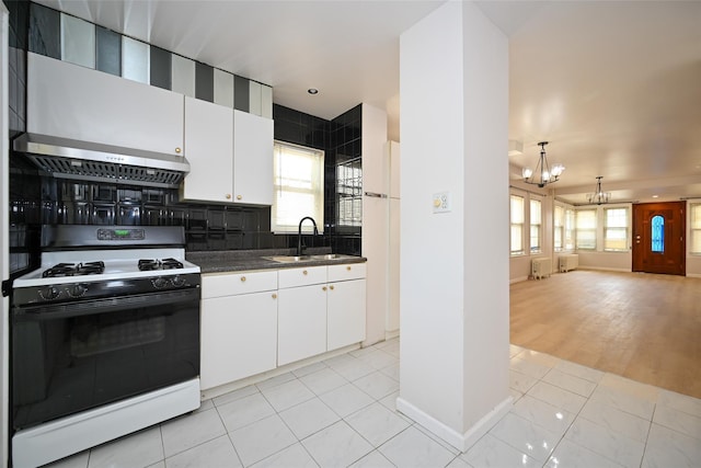43-24 219th St, Bayside, NY 11361 - kitchen featuring white gas range oven, a sink, a chandelier, extractor fan, and radiator