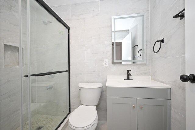 43-24 219th St, Bayside, NY 11361 - bathroom featuring tile walls, vanity, a shower stall, and toilet