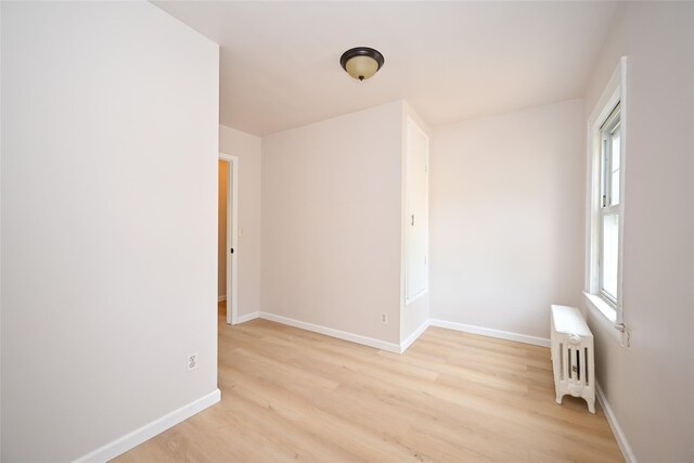 43-24 219th St, Bayside, NY 11361 - unfurnished room featuring radiator, light wood-style flooring, and baseboards