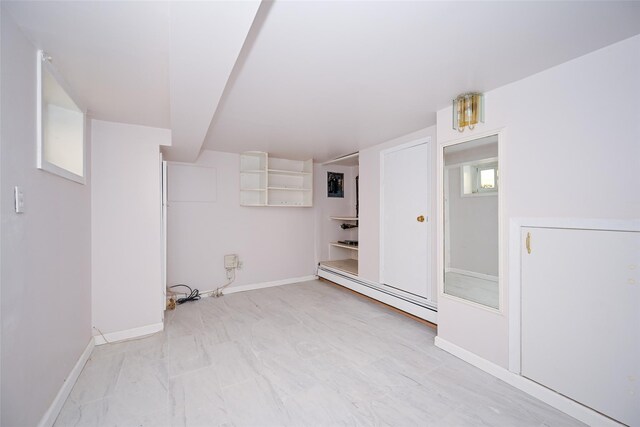 43-24 219th St, Bayside, NY 11361 - below grade area with a baseboard heating unit and baseboards