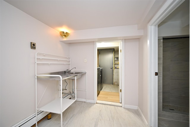 43-24 219th St, Bayside, NY 11361 - washroom with a baseboard heating unit, marble look tile flooring, baseboards, and washer / clothes dryer