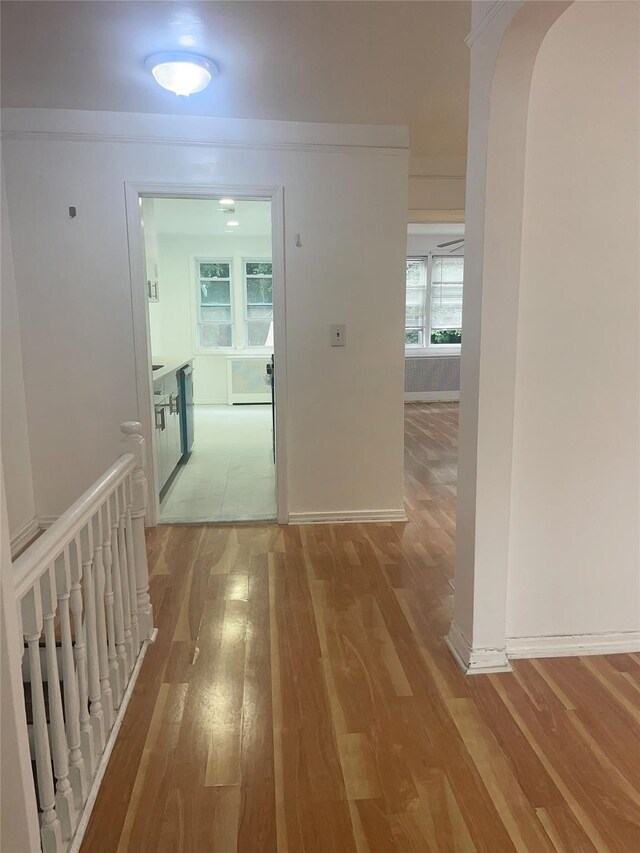 6848 Selfridge St, Forest Hills, NY 11375 - corridor featuring wood finished floors, baseboards, and arched walkways