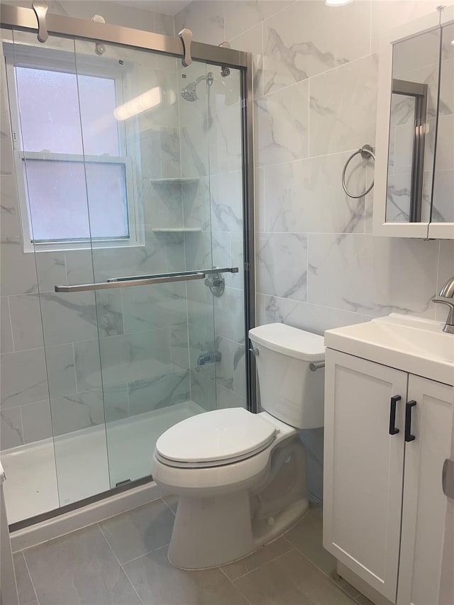6848 Selfridge St, Forest Hills, NY 11375 - full bath with tile walls, a shower stall, toilet, and vanity