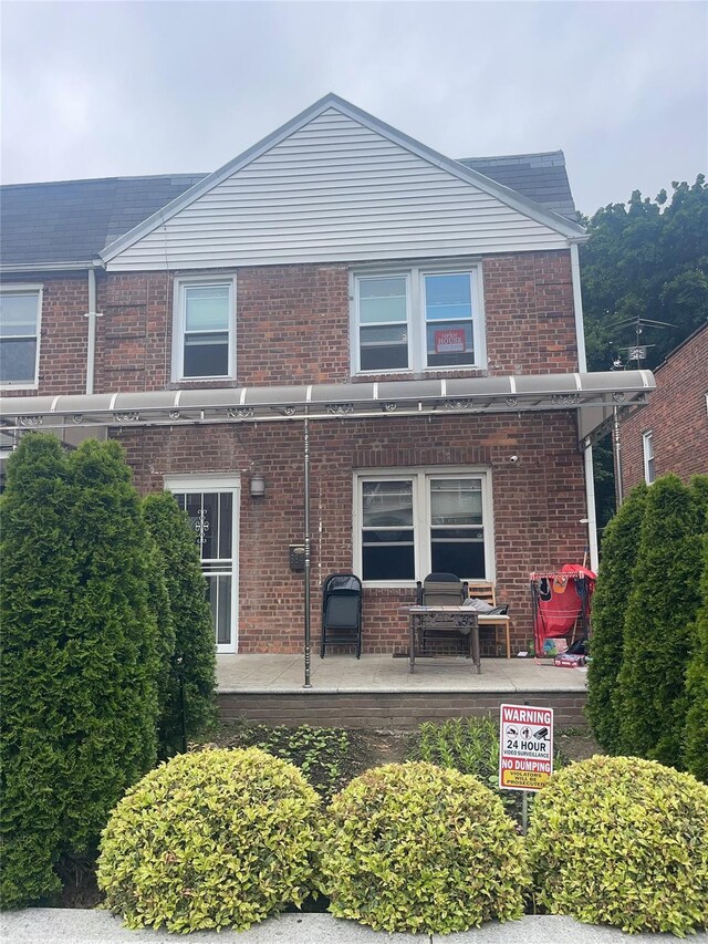 6848 Selfridge St, Forest Hills, NY 11375 - back of house featuring brick siding and a patio area