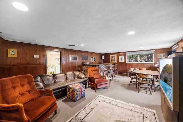 797 Caldwell Ave, North Woodmere, NY 11581 - living area featuring light carpet, a textured ceiling, and wood walls