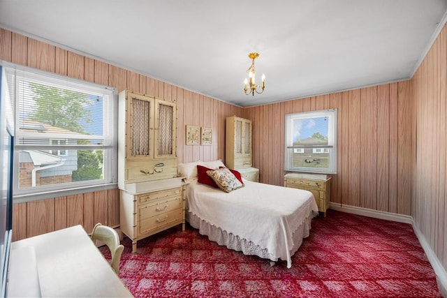 797 Caldwell Ave, North Woodmere, NY 11581 - bedroom featuring a chandelier, wood walls, dark carpet, and baseboards