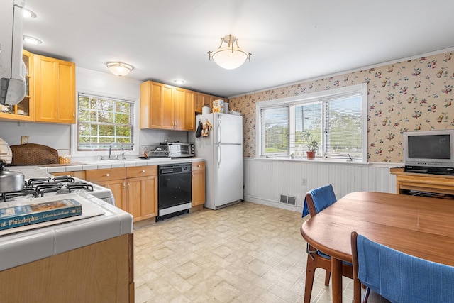45 W 23rd St, Deer Park, NY 11729 - kitchen featuring freestanding refrigerator, black dishwasher, a wainscoted wall, a sink, and wallpapered walls